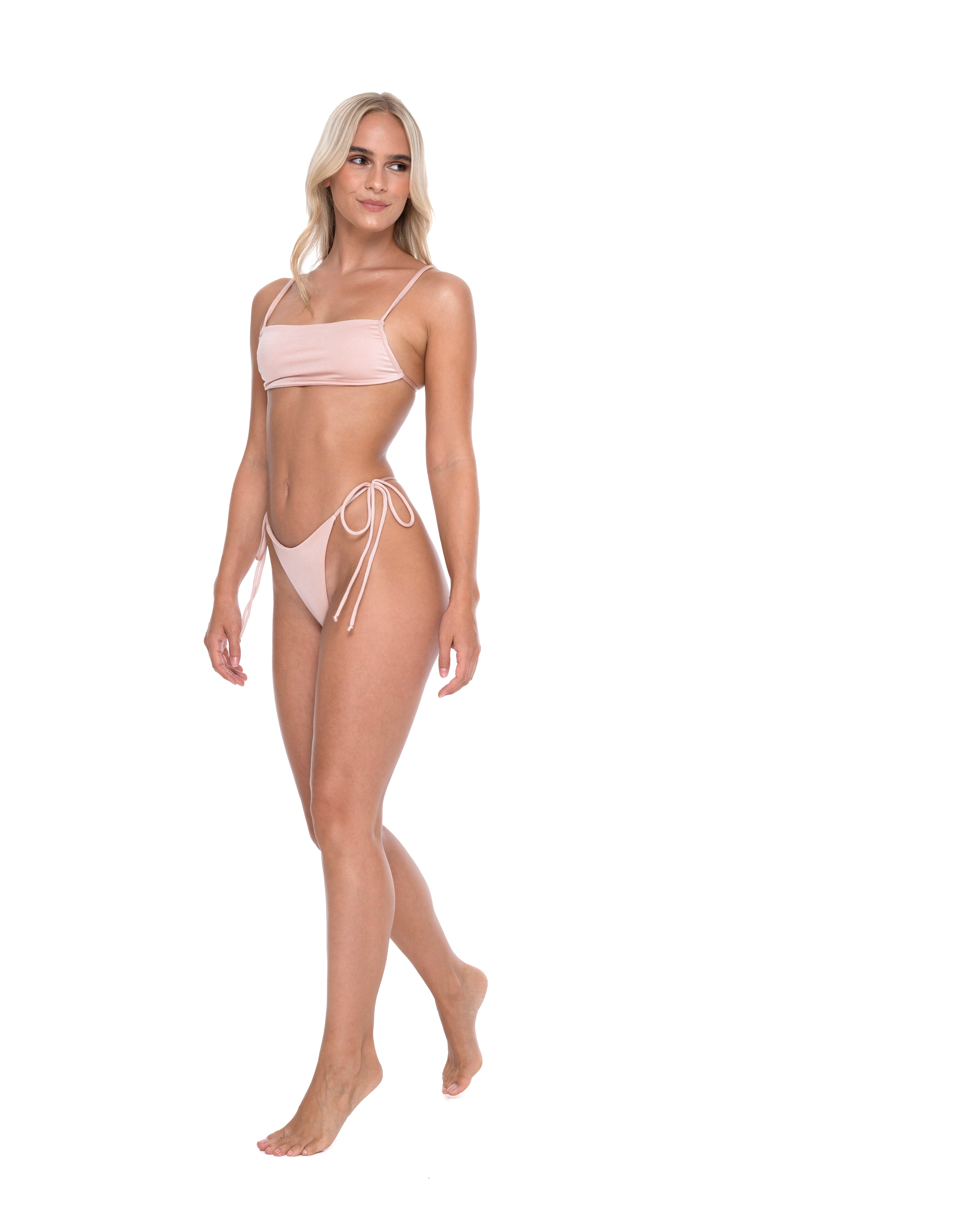 Hoekey light pink bandeau bikini with straight neckline top and tie side bottoms angled walking view women’s swimwear.